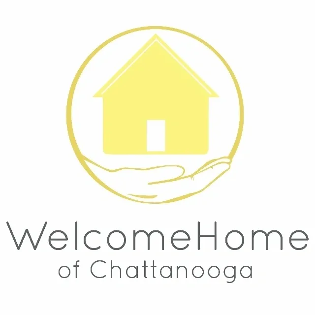 A yellow house with hands and the words " welcomehome of chattanooga ".