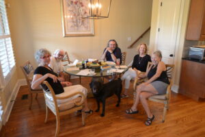 A group of people sitting around a table with food.