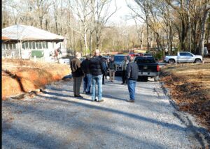 A group of people standing on the side walk