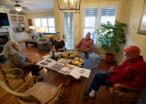 A group of people sitting around a table.